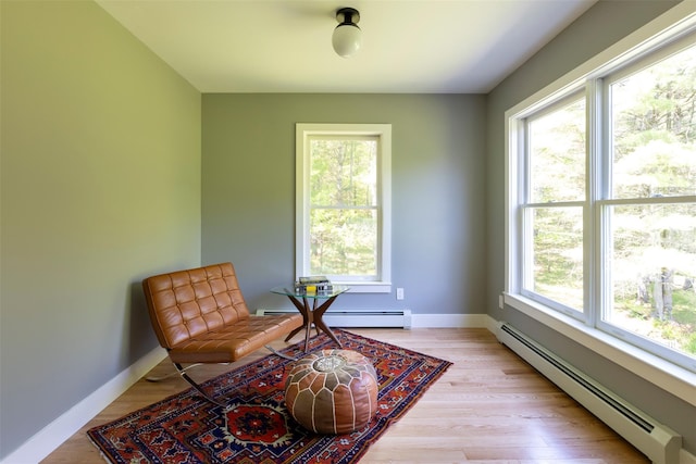 1531 Glasco Tpke, Saugerties, NY 12498 - living area featuring a baseboard heating unit, light wood-style floors, and baseboards