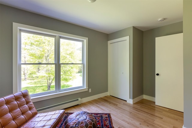1531 Glasco Tpke, Saugerties, NY 12498 - living area with a baseboard heating unit, healthy amount of natural light, baseboards, and light wood-type flooring