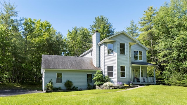 1531 Glasco Tpke, Saugerties, NY 12498 - view of front of house featuring a chimney, covered porch, and a front lawn