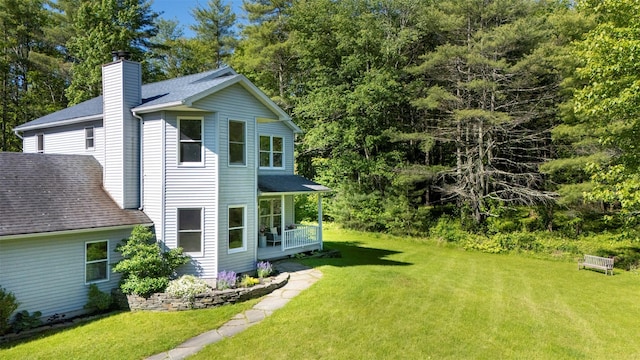 1531 Glasco Tpke, Saugerties, NY 12498 - view of side of home featuring a chimney, a yard, and roof with shingles