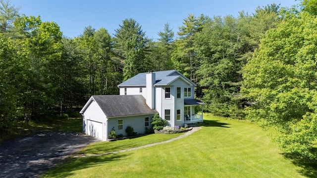 1531 Glasco Tpke, Saugerties, NY 12498 - view of home's exterior with a chimney, a yard, driveway, a wooded view, and an attached garage