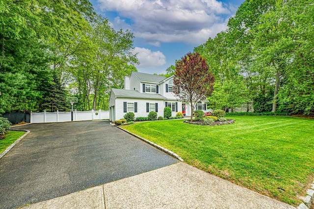 view of front facade featuring asphalt driveway