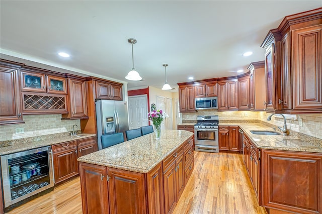 kitchen featuring stainless steel appliances, beverage cooler, a sink, backsplash, and recessed lighting