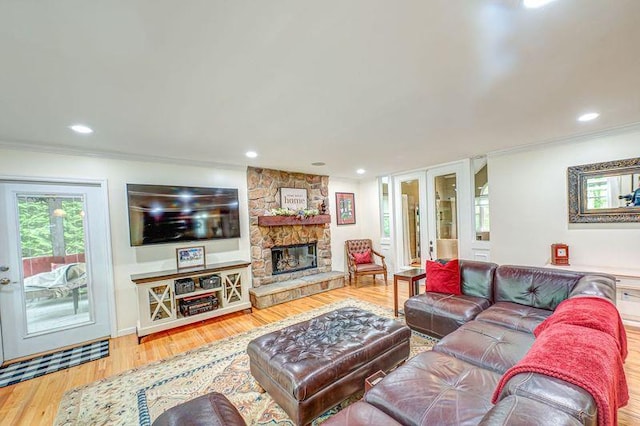 living room featuring ornamental molding, french doors, wood finished floors, recessed lighting, and a fireplace