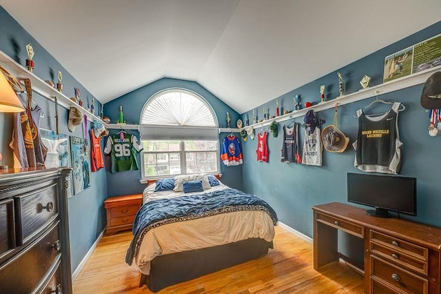 bedroom featuring vaulted ceiling, wood finished floors, and baseboards