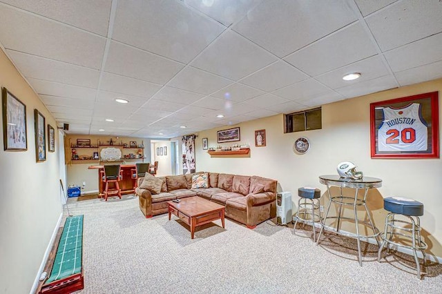 living area with carpet, a bar, a paneled ceiling, baseboards, and recessed lighting