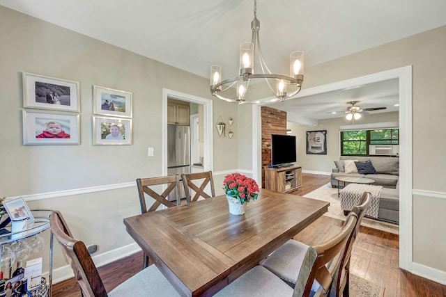 15 Manchester Rd Unit 2L, Eastchester, NY 10709 - dining room featuring a chandelier, ceiling fan, wood finished floors, and baseboards