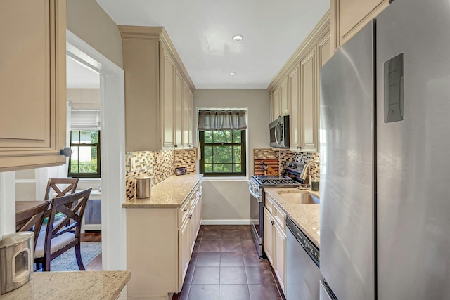 15 Manchester Rd Unit 2L, Eastchester, NY 10709 - kitchen featuring stainless steel appliances, cream cabinetry, a sink, and tasteful backsplash