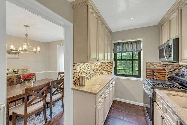 15 Manchester Rd Unit 2L, Eastchester, NY 10709 - kitchen featuring appliances with stainless steel finishes, cream cabinets, and light stone counters