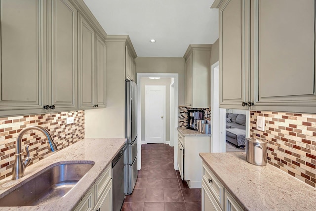 15 Manchester Rd Unit 2L, Eastchester, NY 10709 - kitchen with a sink, backsplash, light stone counters, stainless steel appliances, and dark tile patterned floors