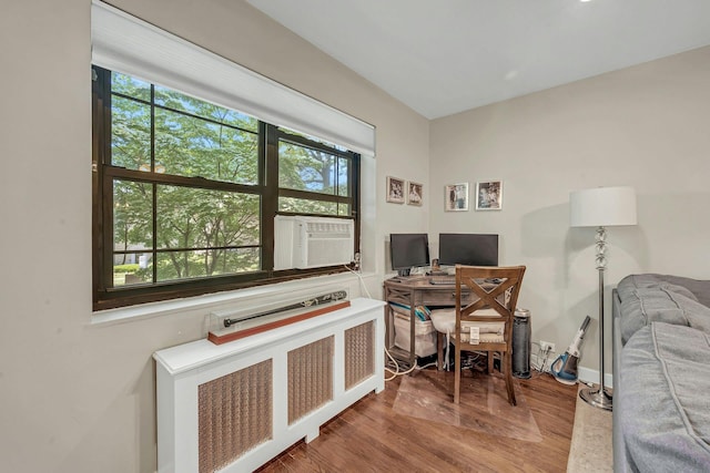 15 Manchester Rd Unit 2L, Eastchester, NY 10709 - home office with radiator heating unit, plenty of natural light, cooling unit, and wood finished floors