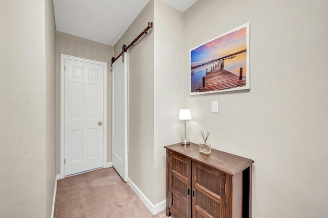 15 Manchester Rd Unit 2L, Eastchester, NY 10709 - hall with a barn door, baseboards, and light colored carpet