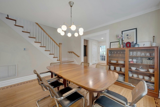 5749 Faraday Ave, Bronx, NY 10471 - dining area featuring stairs, light wood-type flooring, a chandelier, and baseboards