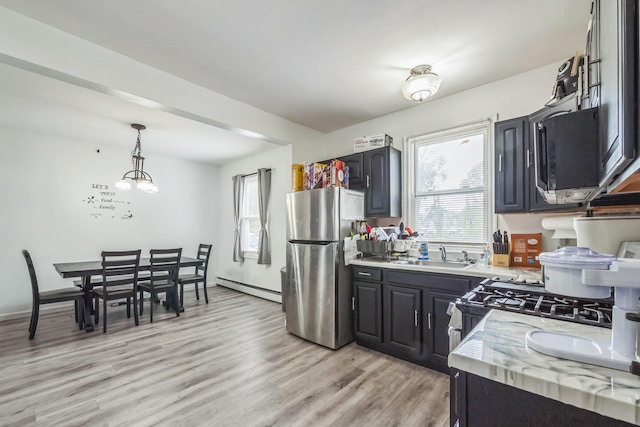 253 N 3rd Ave, Bay Shore, NY 11706 - kitchen with freestanding refrigerator, a baseboard heating unit, light countertops, and plenty of natural light
