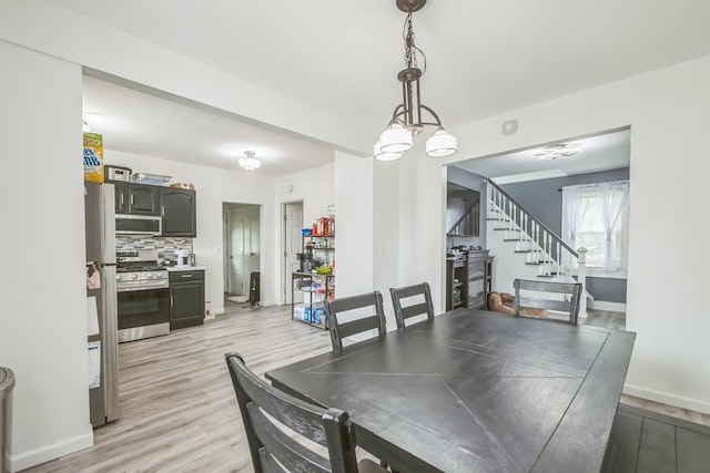 253 N 3rd Ave, Bay Shore, NY 11706 - dining room featuring stairs, light wood finished floors, and baseboards