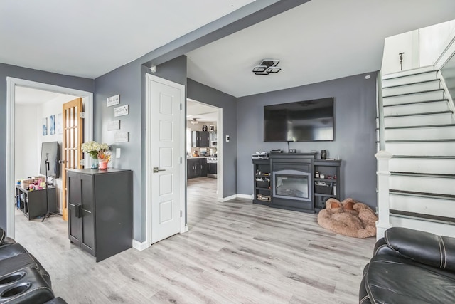 253 N 3rd Ave, Bay Shore, NY 11706 - living room with light wood finished floors, stairway, and baseboards