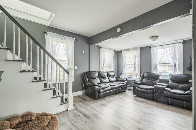 253 N 3rd Ave, Bay Shore, NY 11706 - living room featuring stairway, wood finished floors, baseboards, and a skylight