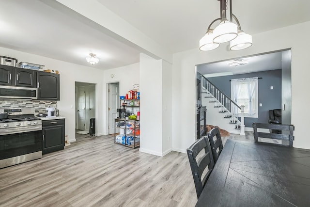 253 N 3rd Ave, Bay Shore, NY 11706 - kitchen featuring appliances with stainless steel finishes, light wood finished floors, backsplash, light countertops, and baseboards