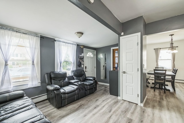 253 N 3rd Ave, Bay Shore, NY 11706 - living area featuring light wood finished floors, a chandelier, and plenty of natural light