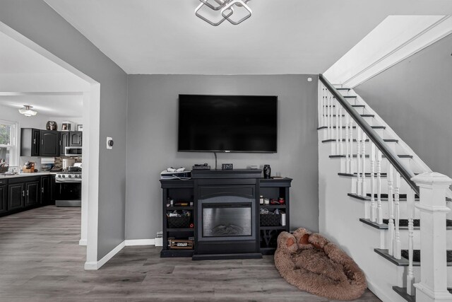 253 N 3rd Ave, Bay Shore, NY 11706 - living room with wood finished floors, stairway, and baseboards