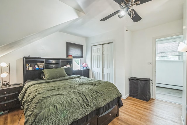253 N 3rd Ave, Bay Shore, NY 11706 - bedroom with baseboard heating, wood finished floors, a closet, ceiling fan, and baseboards