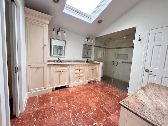 bathroom with a skylight, lofted ceiling, a shower stall, double vanity, and recessed lighting