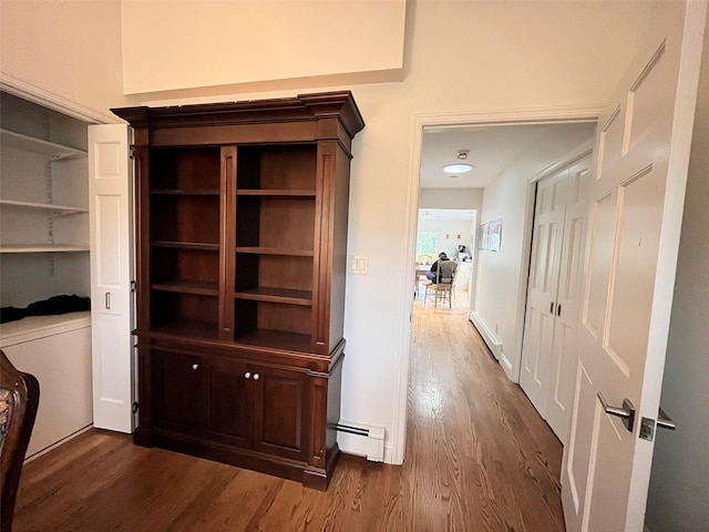 hall featuring baseboard heating and dark wood finished floors