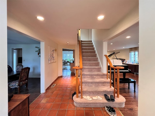 staircase featuring healthy amount of natural light, recessed lighting, and baseboards