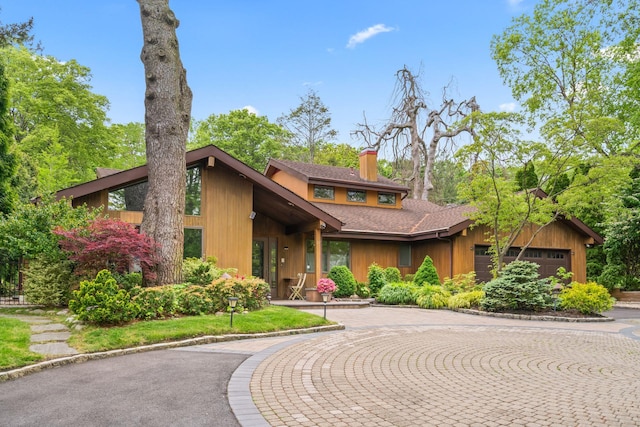 67 Karol Pl, Muttontown, NY 11753 - mid-century home with a chimney, an attached garage, roof with shingles, and curved driveway