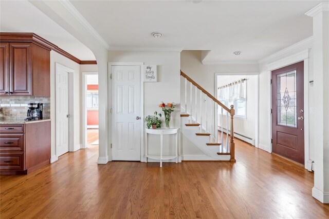 160 Sequams Ln W, West Islip, NY 11795 - entryway with a baseboard heating unit, stairs, light wood finished floors, ornamental molding, and baseboards