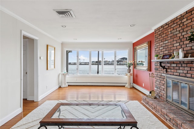 160 Sequams Ln W, West Islip, NY 11795 - unfurnished living room featuring wood finished floors, a baseboard heating unit, ornamental molding, a brick fireplace, and baseboards