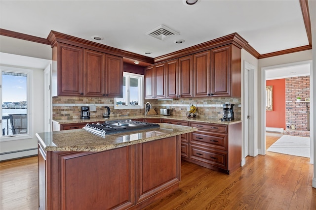 160 Sequams Ln W, West Islip, NY 11795 - kitchen featuring gas cooktop, light wood finished floors, tasteful backsplash, light stone countertops, and ornamental molding