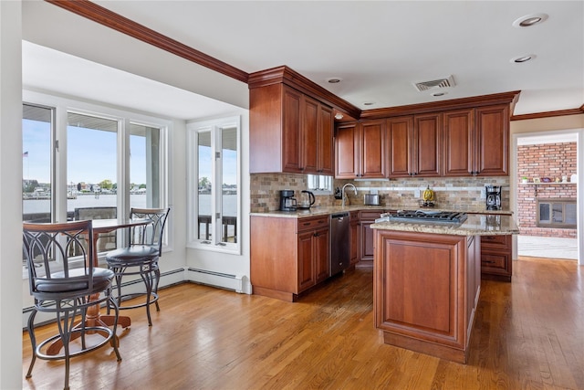 160 Sequams Ln W, West Islip, NY 11795 - kitchen with appliances with stainless steel finishes, tasteful backsplash, a center island, light stone countertops, and crown molding