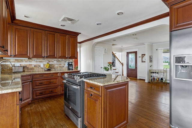 160 Sequams Ln W, West Islip, NY 11795 - kitchen with appliances with stainless steel finishes, dark wood finished floors, ornamental molding, backsplash, and light stone counters