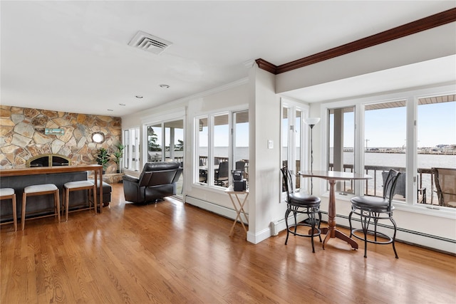 160 Sequams Ln W, West Islip, NY 11795 - living area featuring ornamental molding, wood finished floors, and baseboard heating