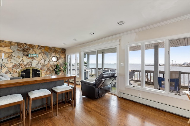 160 Sequams Ln W, West Islip, NY 11795 - living area featuring a baseboard heating unit, ornamental molding, a water view, wood finished floors, and a fireplace