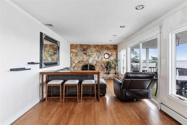 160 Sequams Ln W, West Islip, NY 11795 - living area featuring baseboard heating, healthy amount of natural light, wood finished floors, ornamental molding, and baseboards