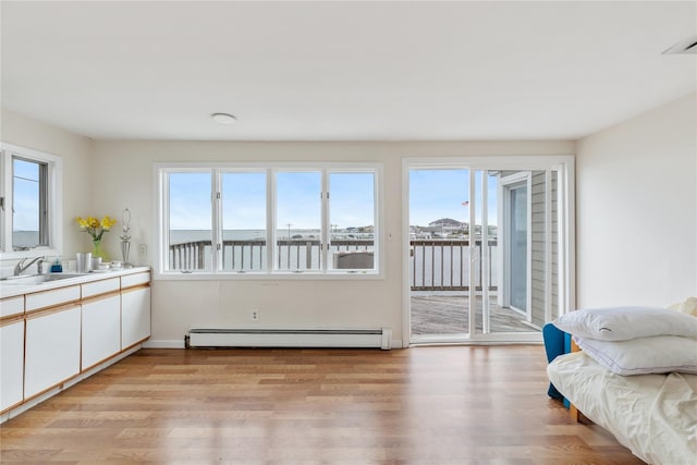 160 Sequams Ln W, West Islip, NY 11795 - living room with baseboard heating, light wood-type flooring, and baseboards