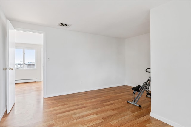 160 Sequams Ln W, West Islip, NY 11795 - workout area with a baseboard radiator, light wood-style flooring, and baseboards