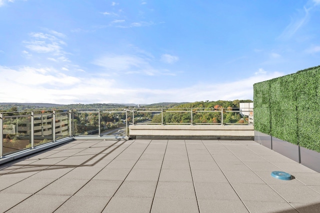 view of patio featuring a balcony