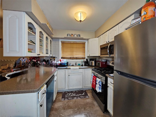 3 Allan Park Mews, Middletown, NY 10940 - kitchen with stainless steel appliances, white cabinets, glass insert cabinets, dark countertops, and stone finish flooring