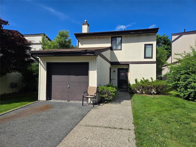 3 Allan Park Mews, Middletown, NY 10940 - view of front of home with asphalt driveway, a chimney, an attached garage, and a front lawn