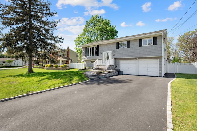 bi-level home featuring an attached garage and driveway