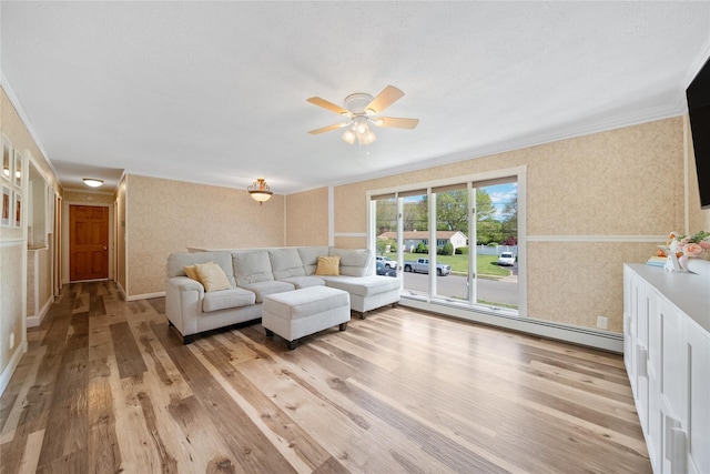 living room with a baseboard radiator, wood finished floors, a ceiling fan, crown molding, and wallpapered walls