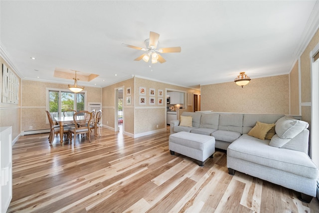 living room with wallpapered walls, light wood-style floors, crown molding, ceiling fan, and baseboards