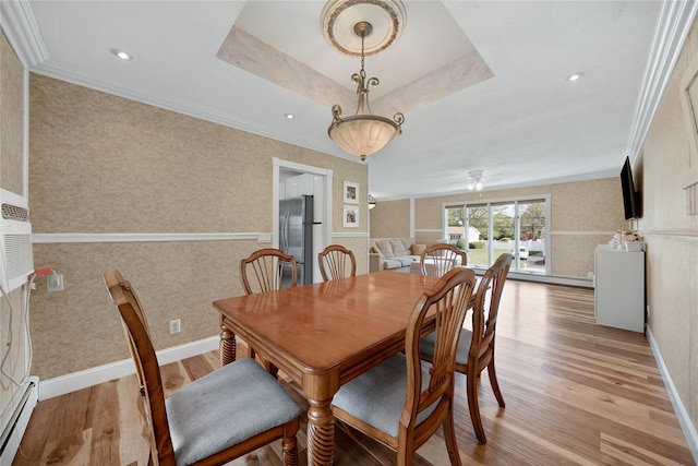 dining room with a baseboard radiator, light wood-style floors, crown molding, a ceiling fan, and wallpapered walls