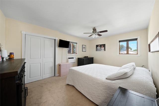 bedroom featuring light carpet, a closet, and a ceiling fan