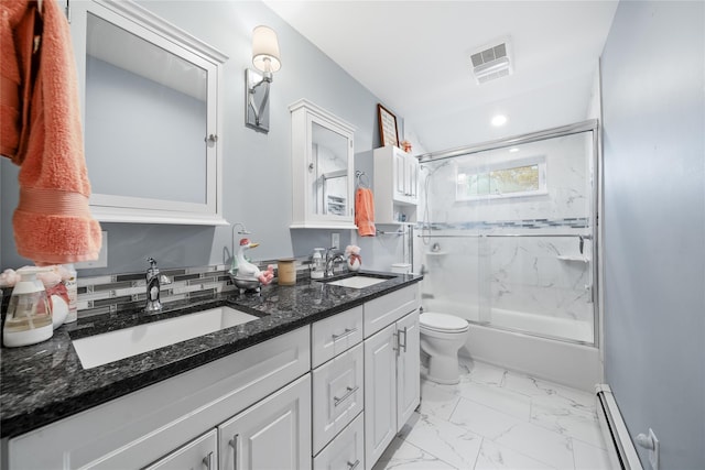 full bath with baseboard heating, marble look tile flooring, toilet, double vanity, and shower / bath combination with glass door