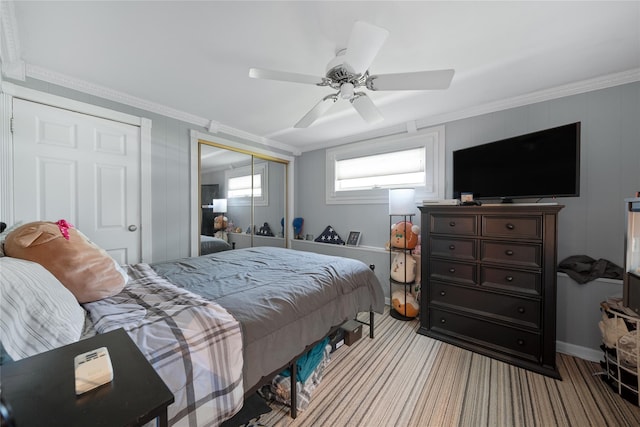 carpeted bedroom featuring ornamental molding, a closet, ceiling fan, and baseboards