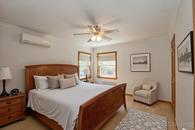 bedroom with radiator heating unit, a wall unit AC, crown molding, light wood-type flooring, and a ceiling fan